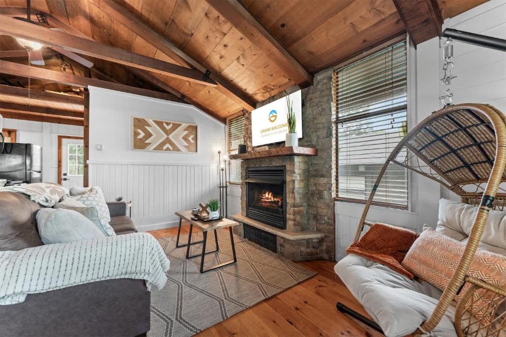 a living room with a couch and a fireplace at Whispering Bass Lodge 3BDR in Kimberling City