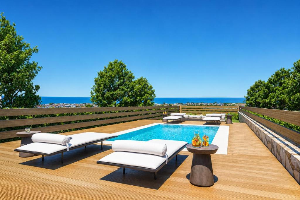 a backyard with a swimming pool and lounge chairs and a swimming poolvisor at Villa Liana in Petalidi