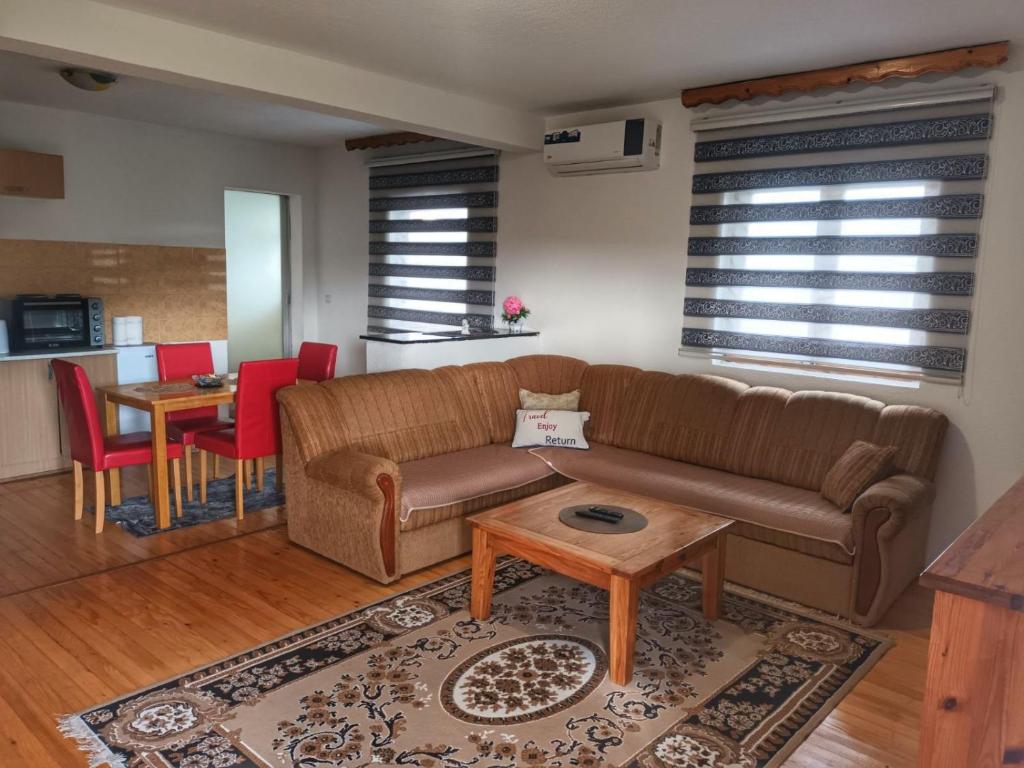 a living room with a couch and a table at Apartment Boka in SJJ