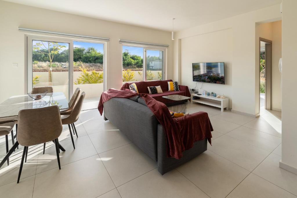a living room with a couch and a table at The Icon 001 - Superior 2BR Apartment with Pool & Gym, Mythical Seas - Protaras in Paralimni