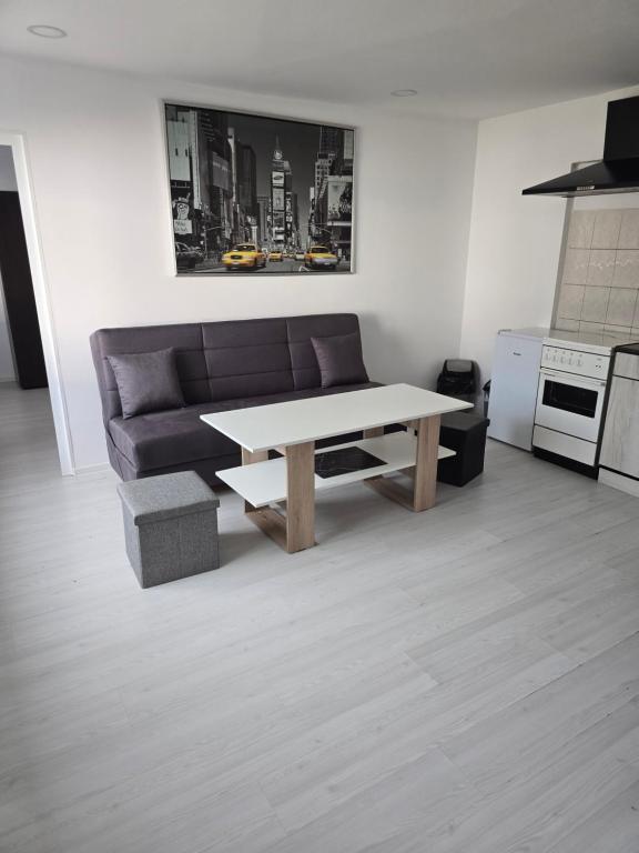 a living room with a couch and a table at Вила Стоянови in Yasen