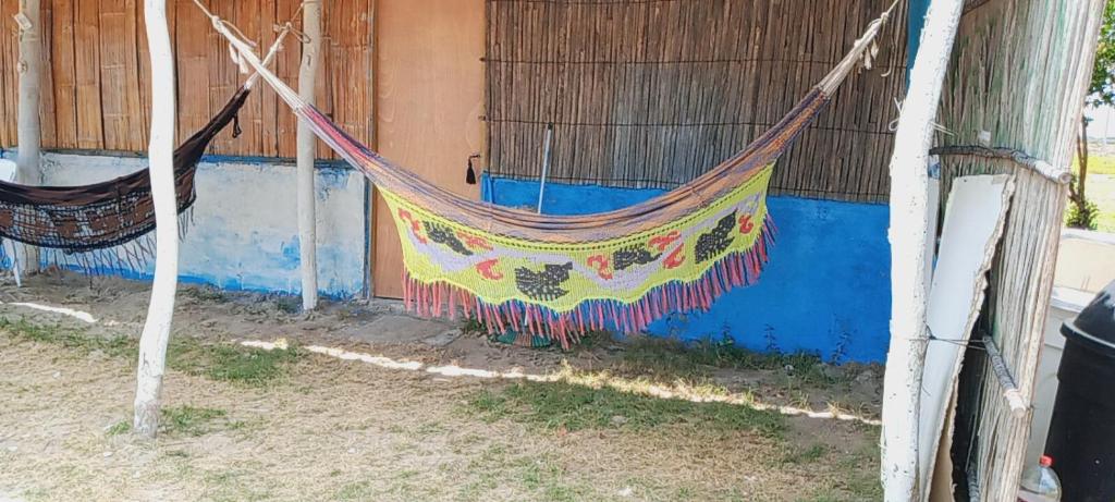 a colorful hammock hanging from a building at Kaigeemayapo in Manaure