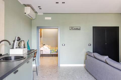 a kitchen with a couch and a living room with a bed at Walk to Fly Gate 65 Appartaments in Naples