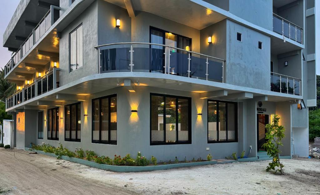 a building with a balcony on top of it at Rindhali Thoddoo in Thoddoo