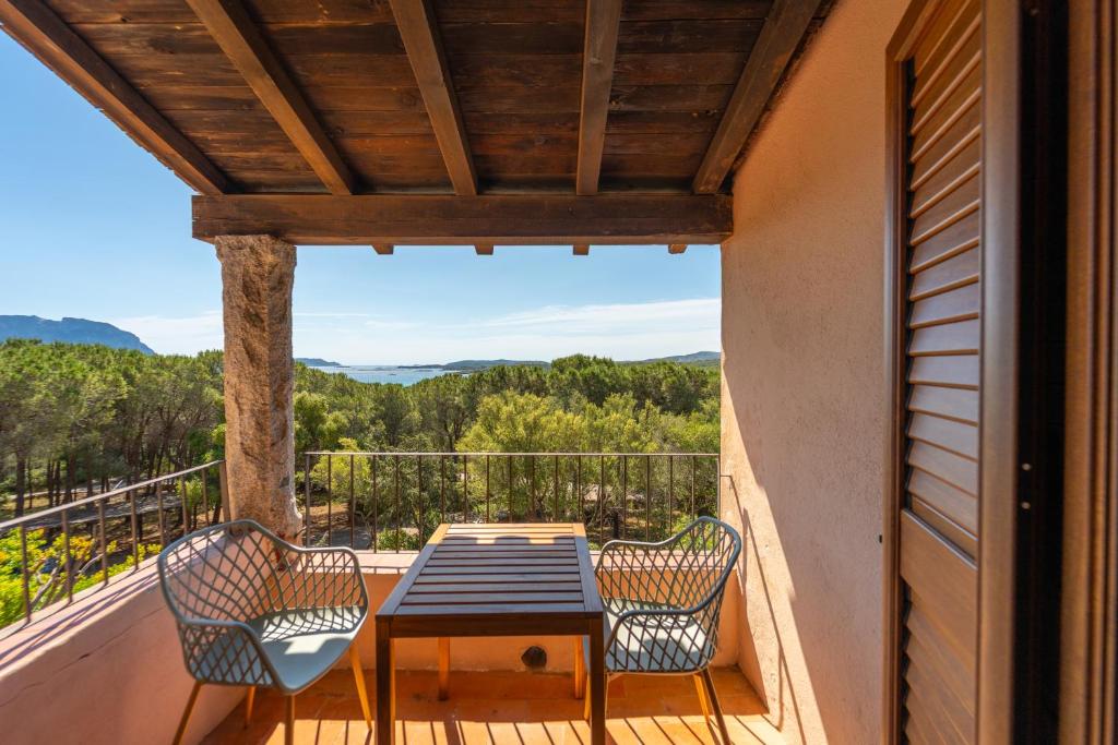 a patio with a table and chairs on a balcony at Mury by DomusAway in Porto Istana