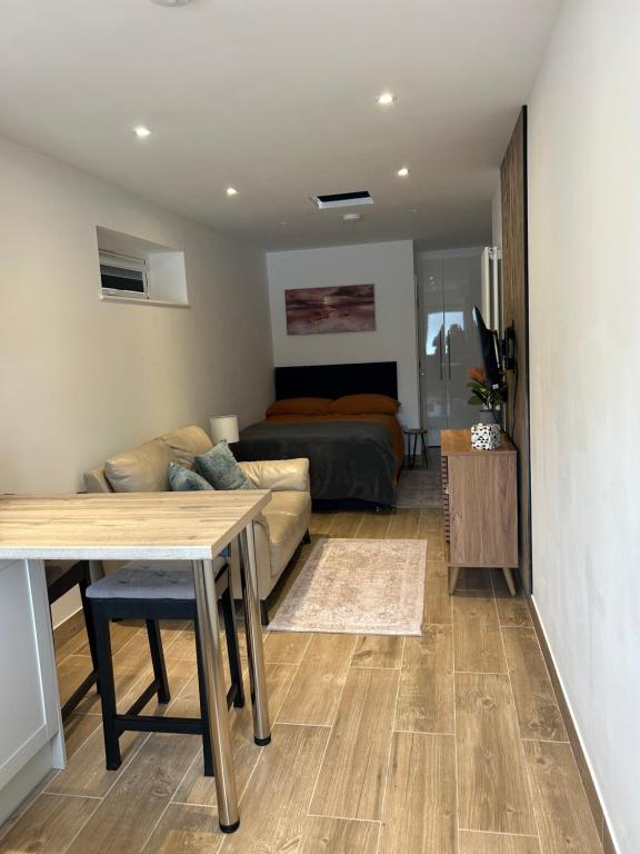 a living room with a bed and a table at Holyport Studio flat in Bray
