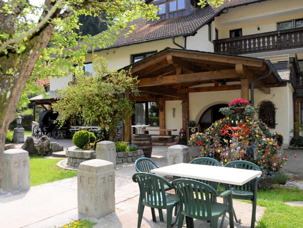 a table and chairs in front of a house at Café Pension Leistner in Obertrubach