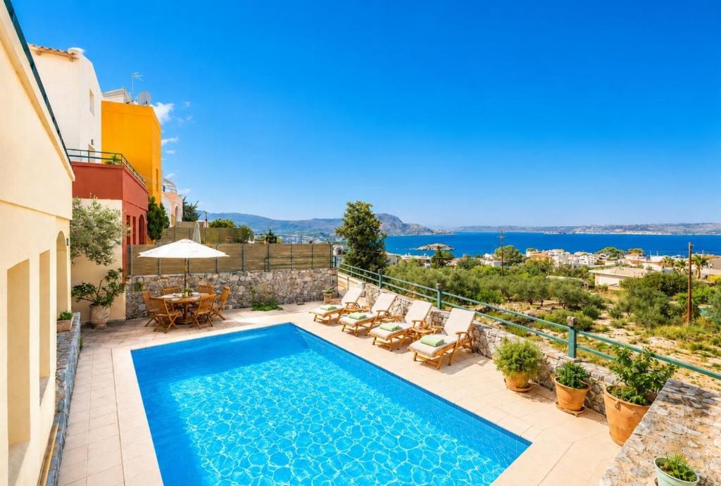 a villa with a swimming pool and a view at Villa Aphrodite in Plaka