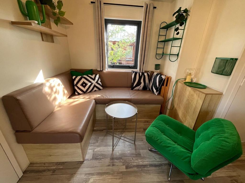 a small living room with a couch and a table at La Cabane du Lac - Biscarrosse 5 étoiles in Biscarrosse