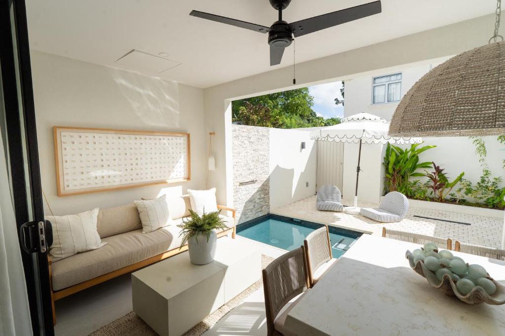a living room with a couch and a table at Stylish West Coast 3BR Retreat with Pool Near Beach in Saint James