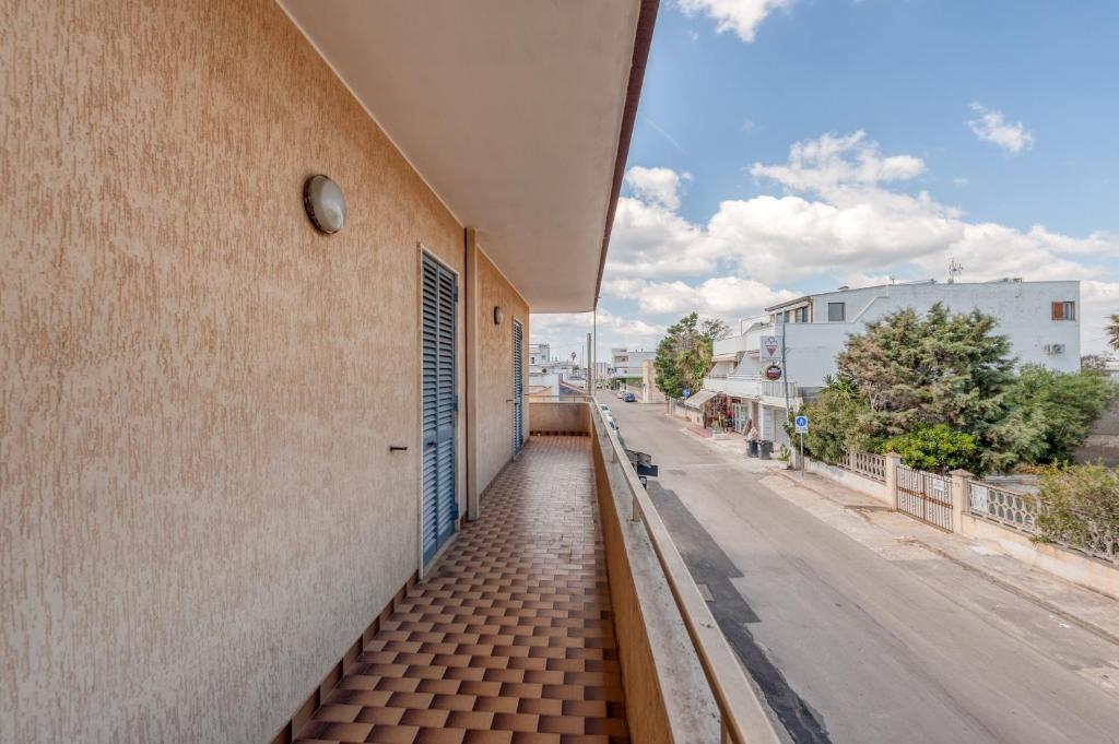 a building with a walkway next to a street at Casa Lucia a Torre Lapillo in Torre Lapillo