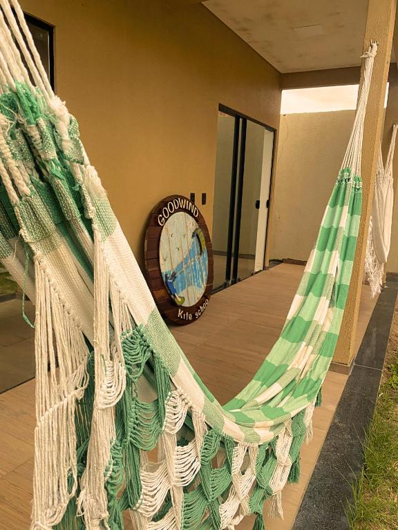 a hammock in a room with a clock at Good Winds Kite House in Cruz