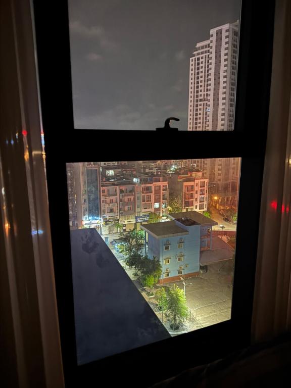a view from a window of a city at night at 7Homestays in Ðông Khê
