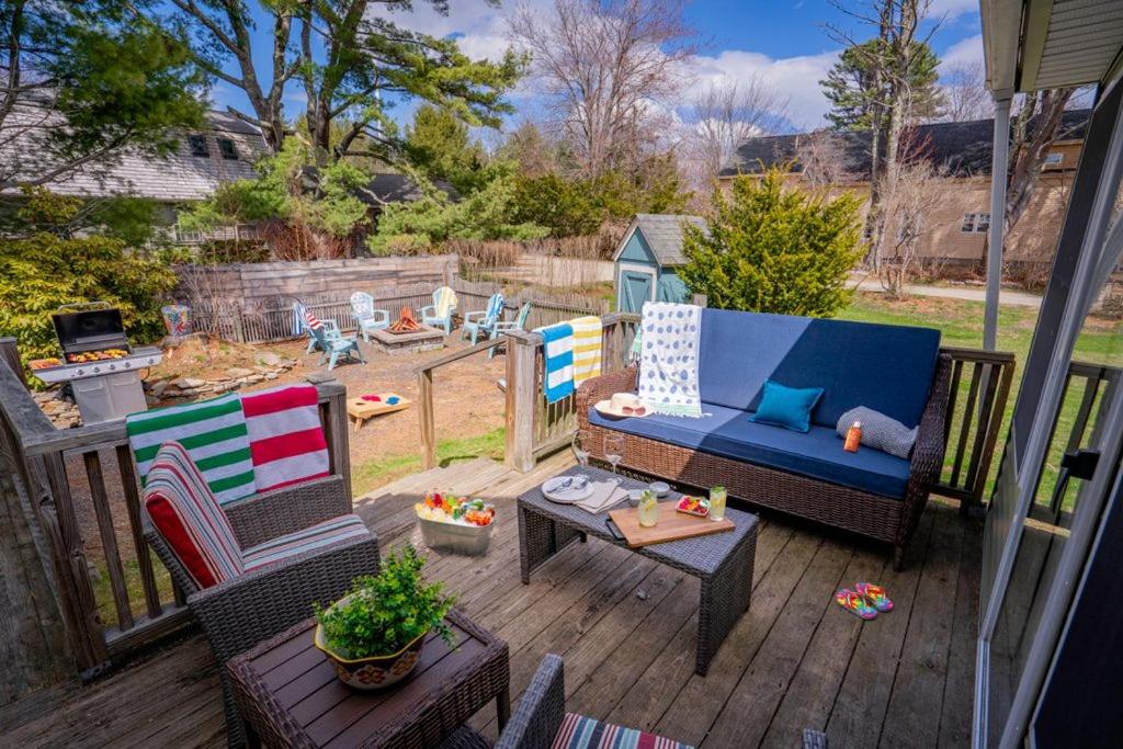 a patio with a couch and chairs on a deck at Charming Kennebunk Cape - Walk to Dock Square! in Kennebunk