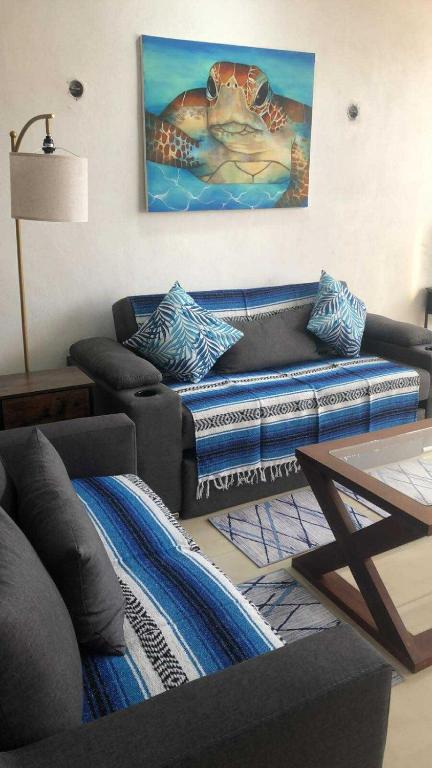 a living room with a couch and a table at Casa Las Brisas in Progreso