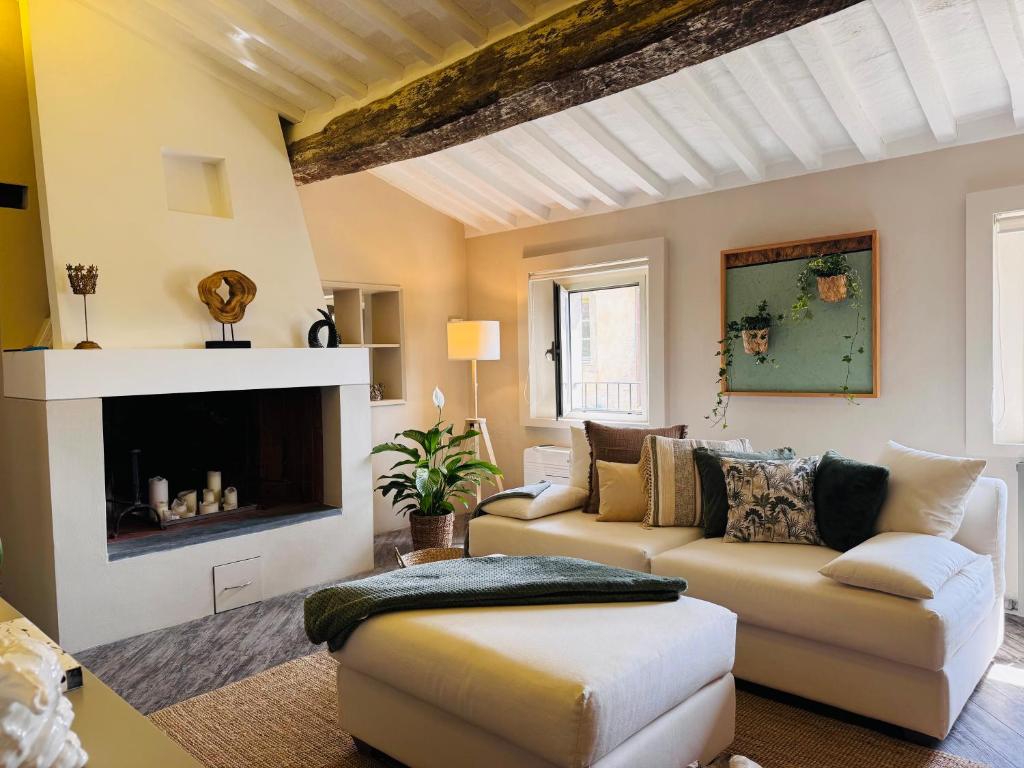a living room with a couch and a fireplace at La Casetta di Borgo Appartamento Albero in Lajatico