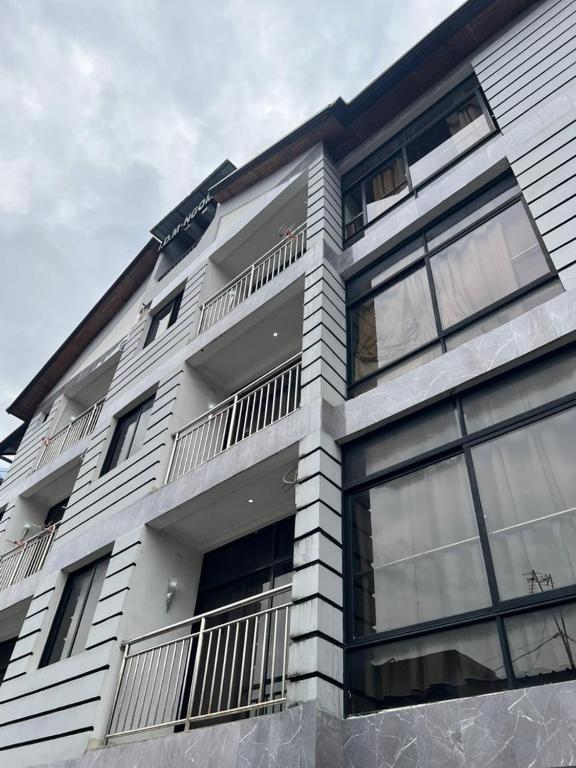 a white building with balconies on the side of it at RÉSIDENCE IDM-Ngoma in Kinshasa