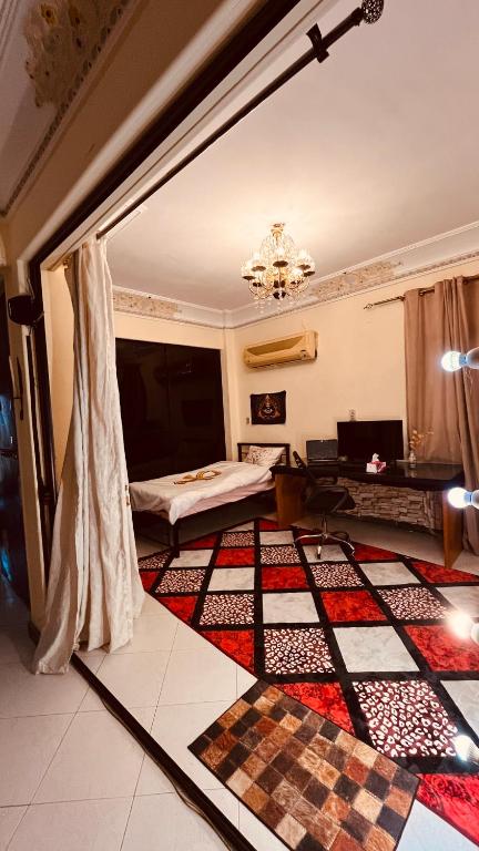 a room with a bed and a checkerboard floor at Temple host in Cairo