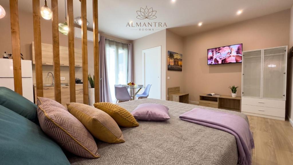 a bedroom with a bed with pillows on it at Almantra Rooms - Valle dei Templi e Mare in Favara