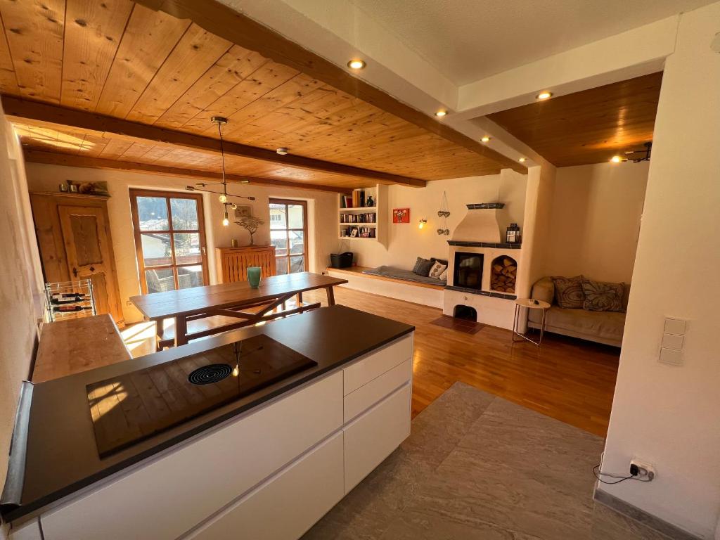 a kitchen and living room with a wooden ceiling at Ferienwohnung Wildbichl in Sachrang in Sachrang