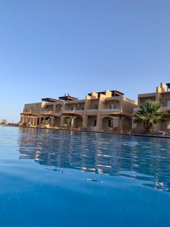a large swimming pool in front of a building at Arwaa Boutique in Dahab