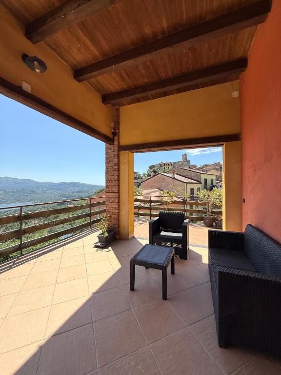a patio with chairs and a table and a view at Casa Vacanze Panoramika Santa Cruz - FAMILY ROOM in Cicerale