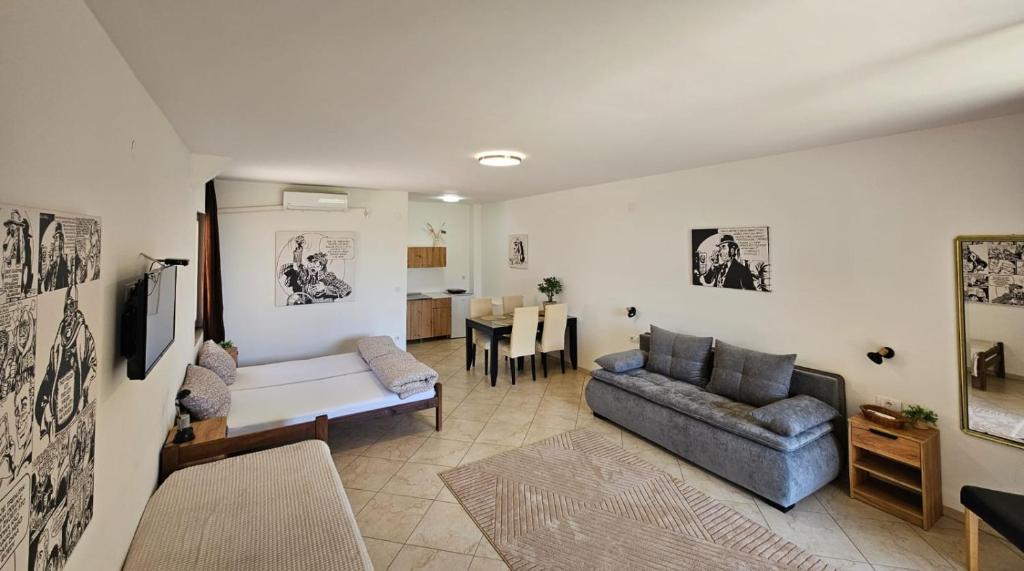 a living room with a couch and a table at SOBE AVA in Palić