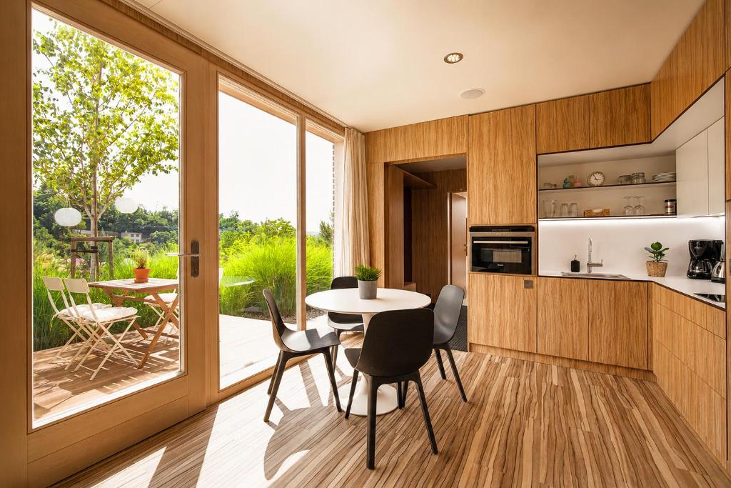 a kitchen and dining room with a table and chairs at Nedomek by Homester in Neslovice