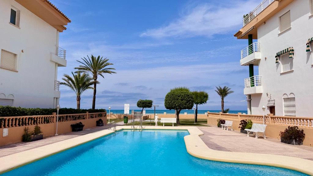 a swimming pool in front of a building at Talima Vyb Dénia in Denia