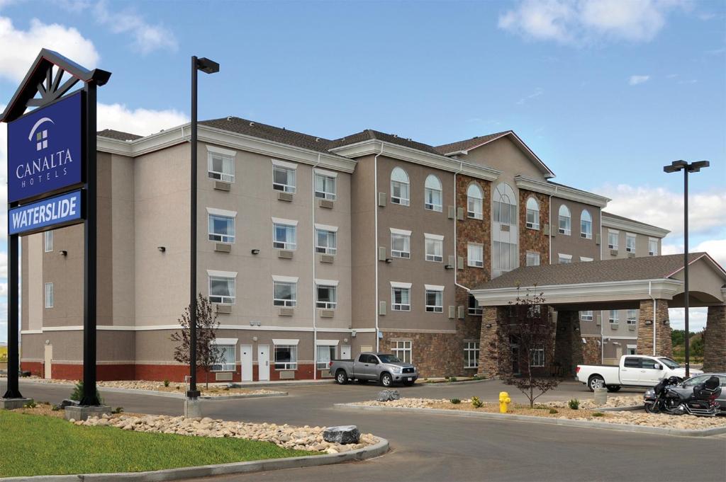 a hotel with a sign in front of a building at Canalta Wainwright in Wainwright