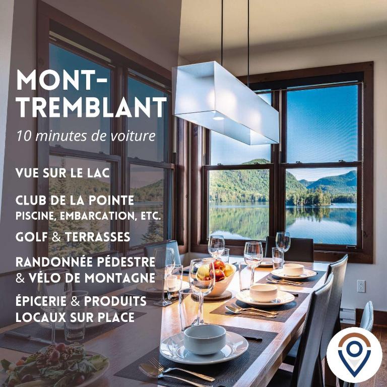 a dining room with a table and a chandelier at Lakefront, Mountain View - 3 Bedrooms Resort Suite in Lac-Superieur