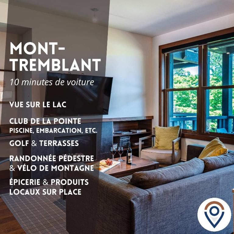 a living room with a couch and a tv at Lakefront, Mountain View - Resort Loft in Lac-Superieur
