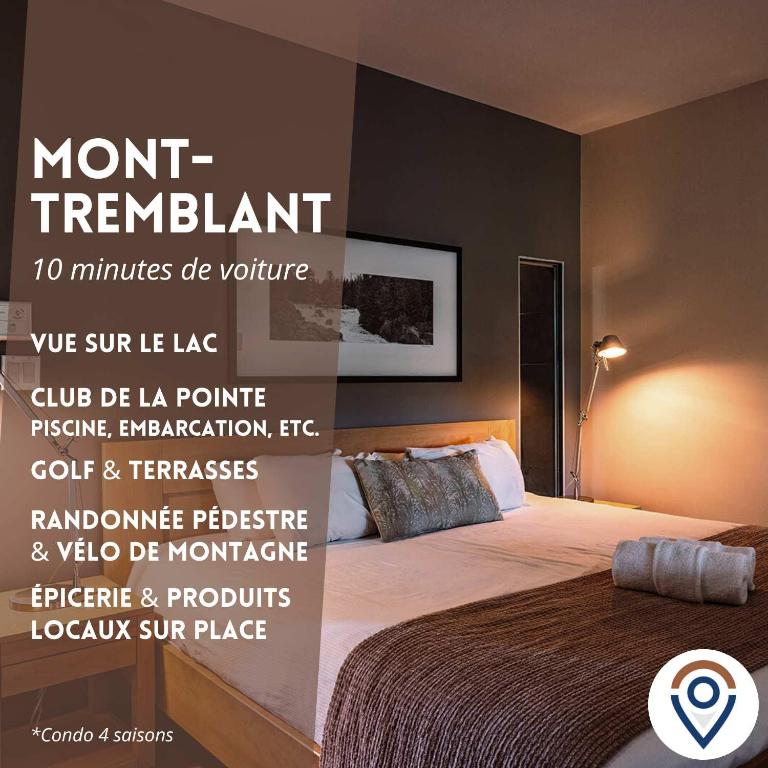 a bedroom with a bed with a poster on the wall at Lakefront Mountain View - Resort Access Loft in Lac-Superieur