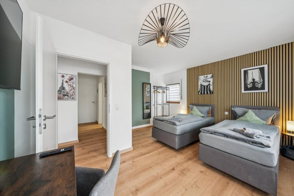 a living room with two couches and a chandelier at SleepHaven in Walldürn
