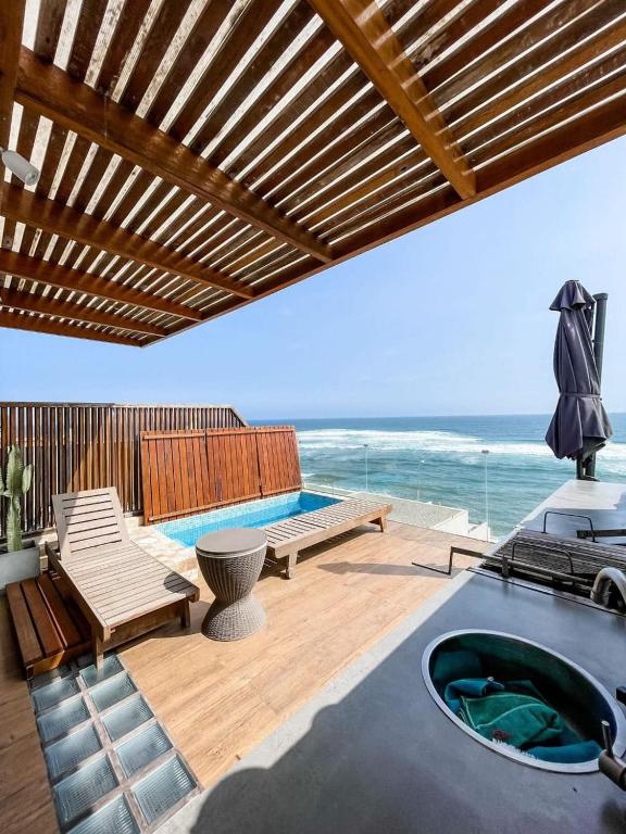 a patio with a hot tub and a view of the ocean at Oceanview 2BR with Terrace in Punta Hermosa in Punta Hermosa