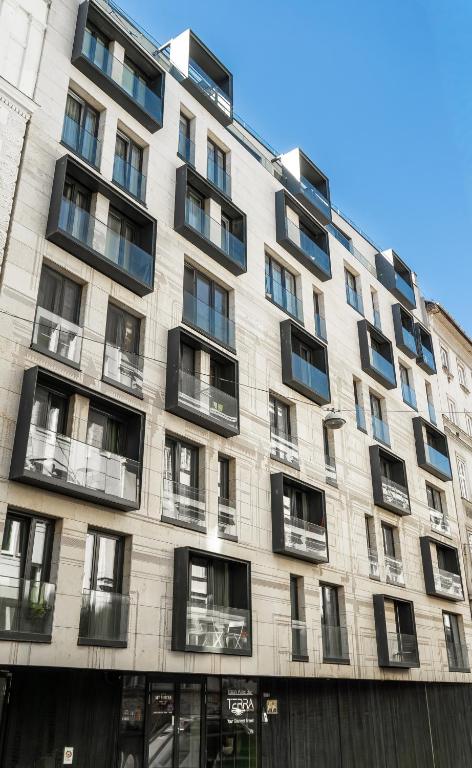 a large apartment building with black windows at MT Suites ApartHotel in Budapest
