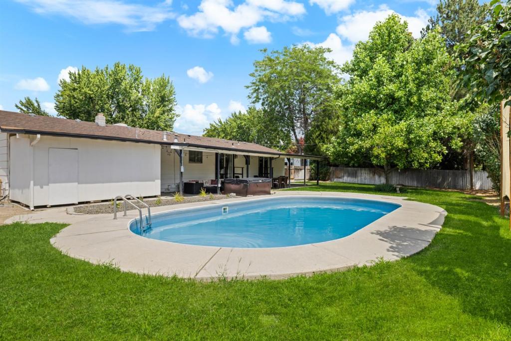 a swimming pool in the yard of a house at Poolside Paradise with Hot Tub in Boise