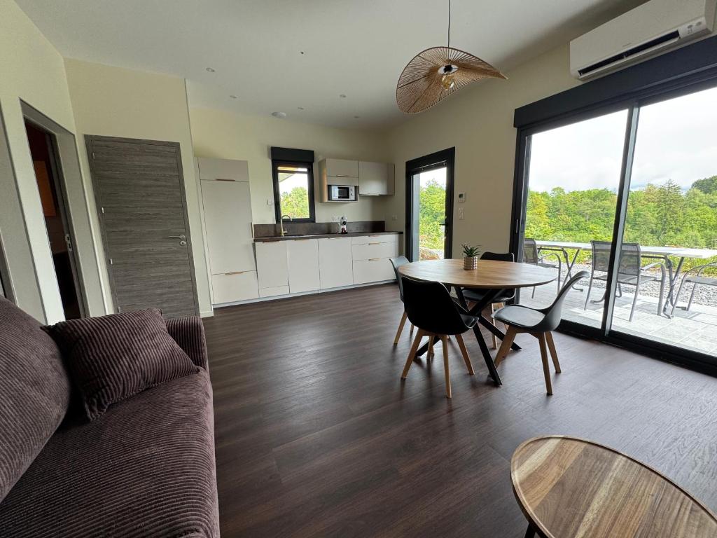 a living room with a couch and a table at Brin d'Air Lodge in Montcornet