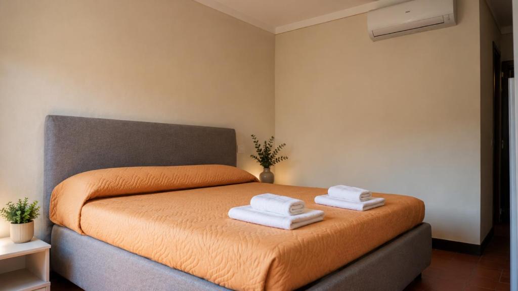 a bedroom with a bed with two towels on it at la Pace camere con bagno nel centro storico di Stia in Stia