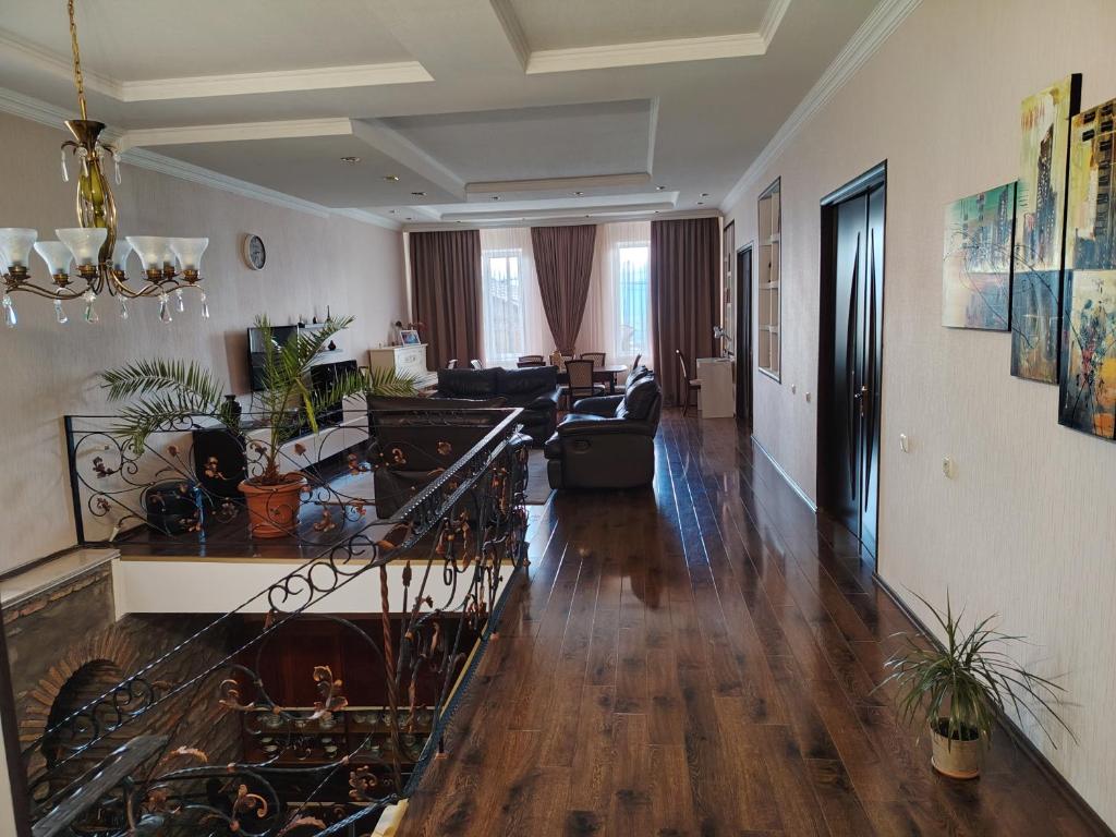 a living room with a staircase leading to a living room at Marinella in Telavi