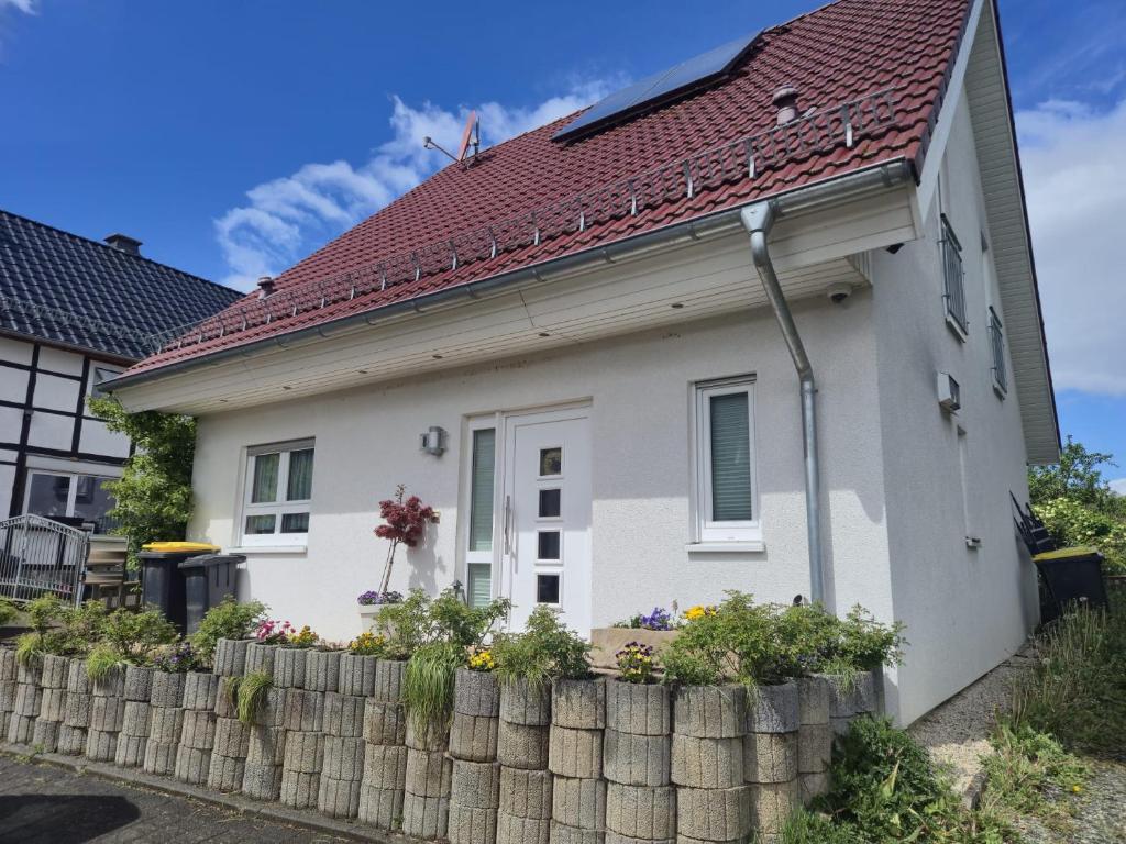 a white house with a red roof at Haus Else am Nationalpark Eifel in Schleiden