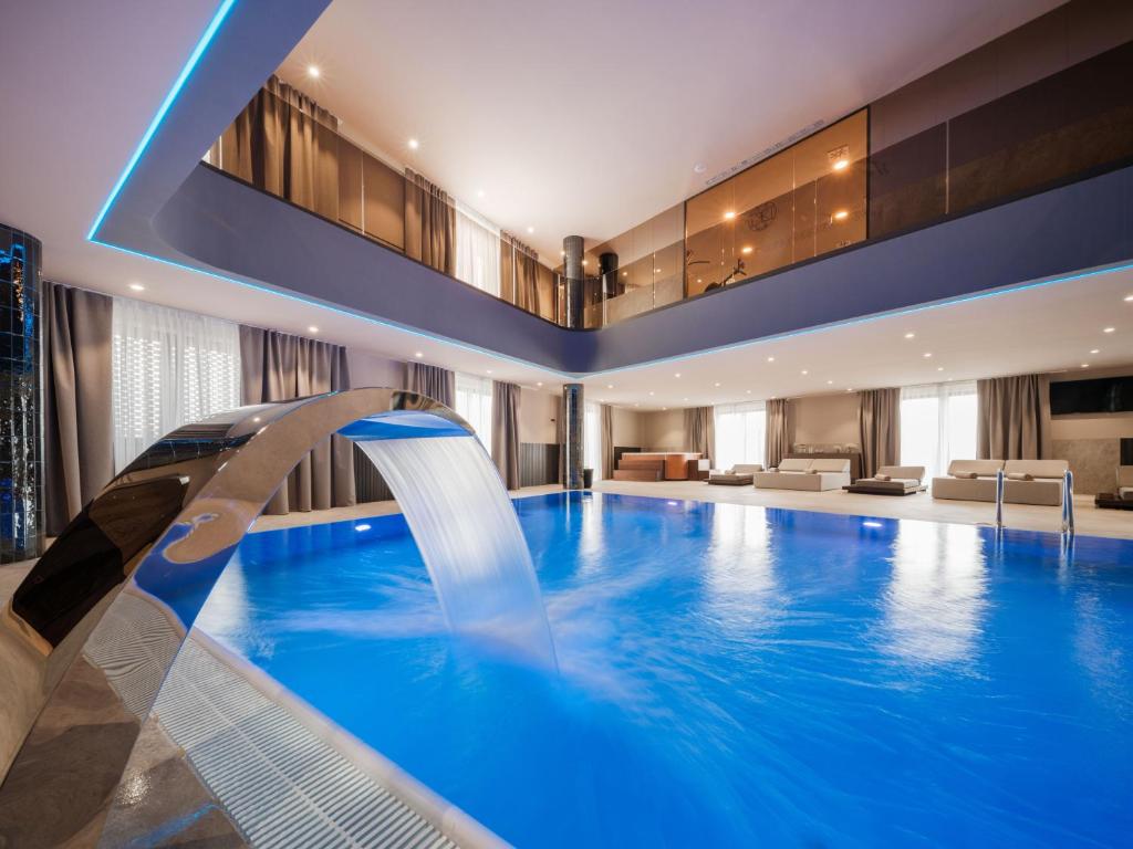 a pool in a hotel room with a swimming pool at Diaco Boutique Hotel in Đakovo