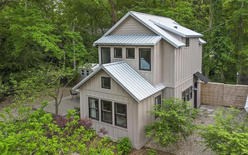 a small house with a tin roof on top of it at Townie 4 - The Fern by Juniper Holiday + Home in Union Pier