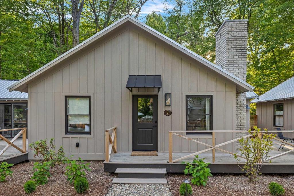 a small white house with a porch and a door at Townie 2 - The Sage by Juniper Holiday + Home Unit in Union Pier
