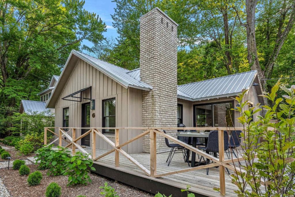 a small house with a deck and a chimney at Townie 3 - The Moss by Juniper Holiday + Home in Union Pier