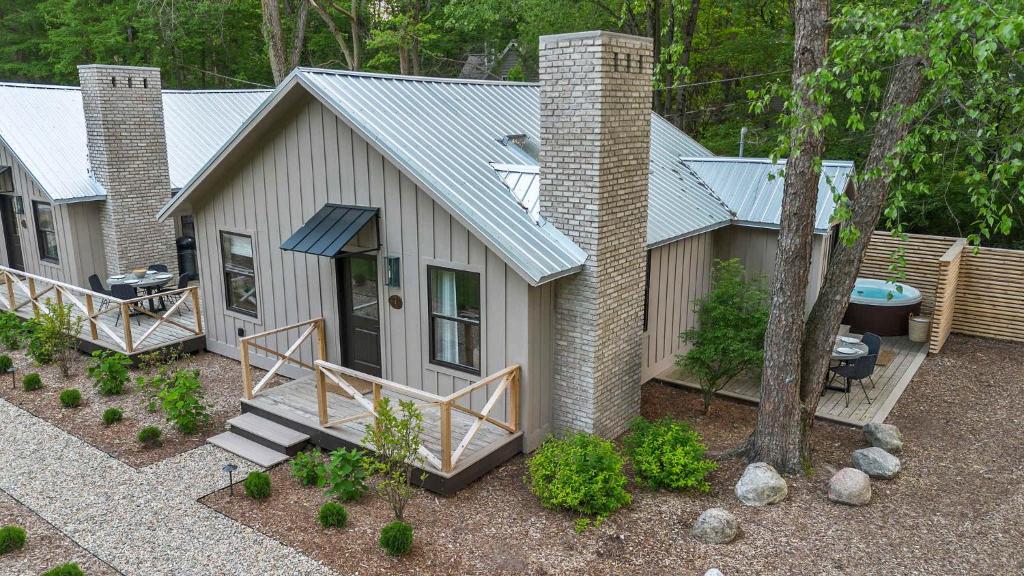 an aerial view of a house with a porch at Townie 1 - The Ivy by Juniper Holiday + Home in Union Pier