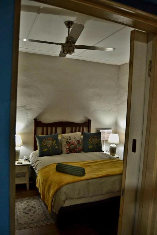 a bedroom with a bed and a ceiling fan at 22 Symmonds Studio in Melmoth