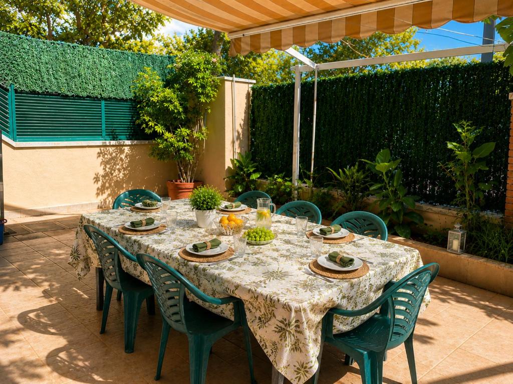 a table with chairs and a tablecloth on a patio at PLATANERA apart in Calafell