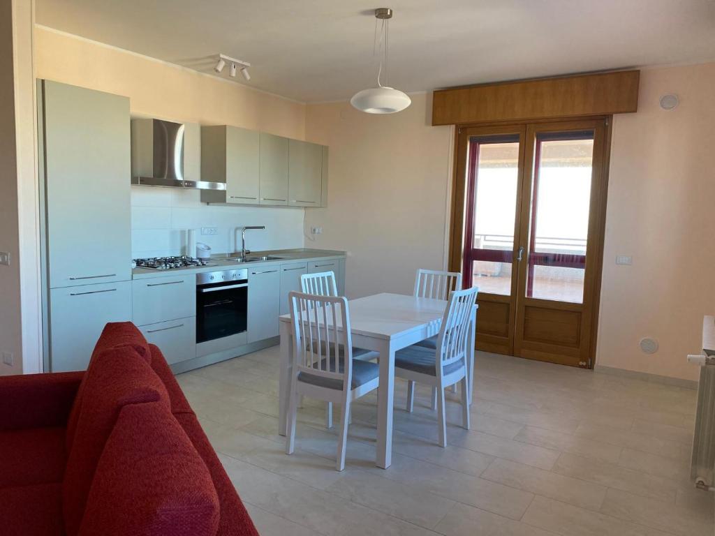 a kitchen with a table and chairs in a room at La casa di John in Guglionesi
