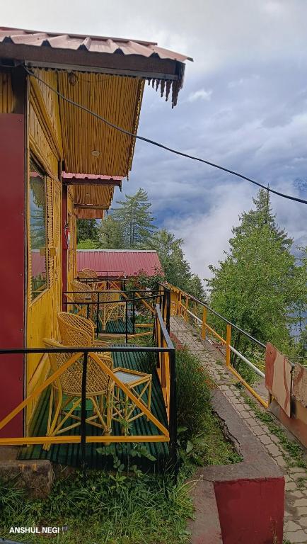 a restaurant with tables and chairs on a building at Chauhan bambo house in Joshīmath